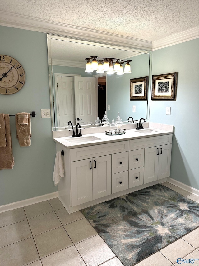 bathroom with ornamental molding, a sink, a textured ceiling, and double vanity