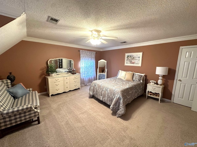 bedroom featuring visible vents, lofted ceiling, ceiling fan, crown molding, and carpet flooring