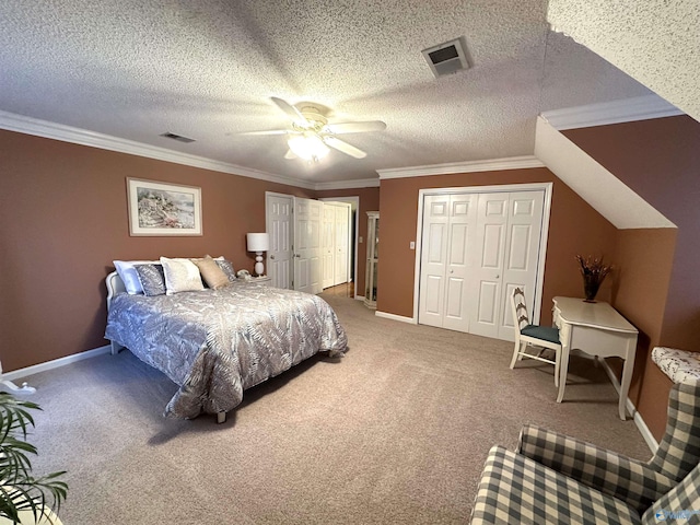 carpeted bedroom featuring two closets, a textured ceiling, visible vents, and crown molding