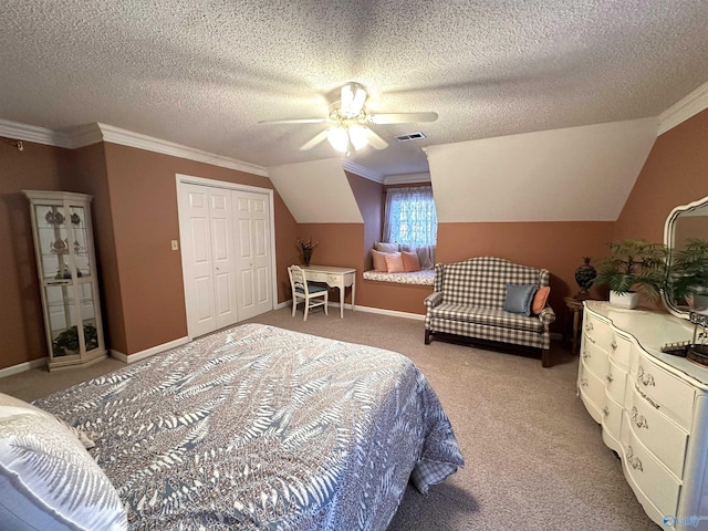 bedroom featuring lofted ceiling, ceiling fan, ornamental molding, carpet flooring, and a closet