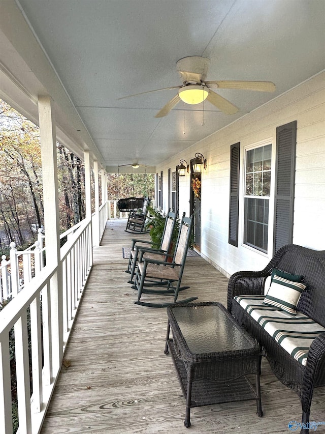 deck featuring a porch and a ceiling fan