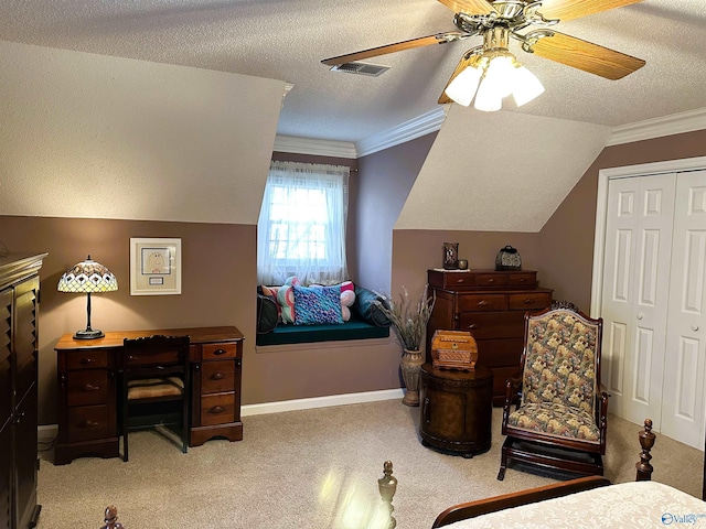 bedroom with a textured ceiling, ornamental molding, a closet, and light carpet