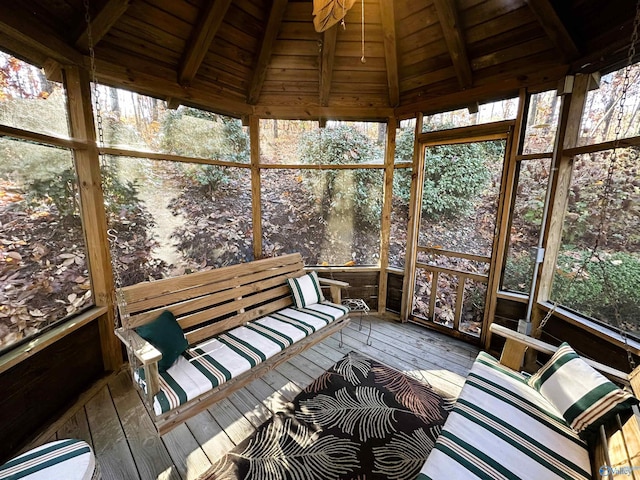 unfurnished sunroom with vaulted ceiling with beams and wooden ceiling