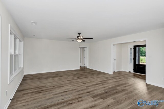 unfurnished living room featuring wood-type flooring and ceiling fan