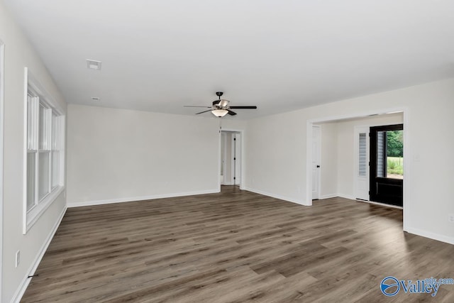 unfurnished room featuring dark hardwood / wood-style flooring and ceiling fan