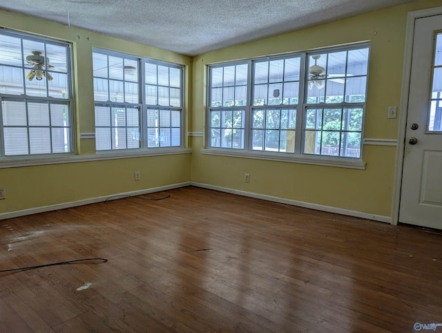 interior space with a textured ceiling, hardwood / wood-style flooring, and ceiling fan