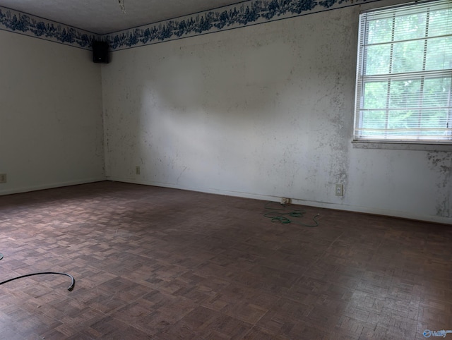 empty room featuring dark parquet flooring