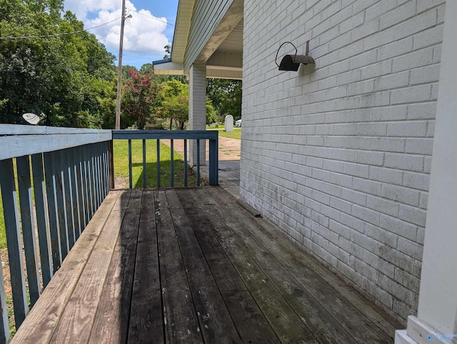 wooden terrace with a yard