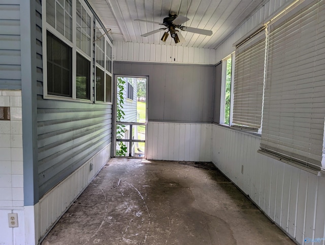 unfurnished sunroom with ceiling fan and plenty of natural light