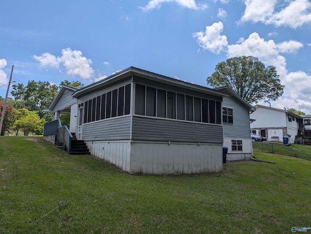 view of property exterior with a yard and a sunroom