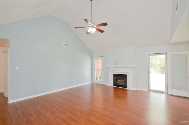 1422 Lake Crest Dr SW, Decatur, AL 35603 - unfurnished living room featuring high vaulted ceiling, a ceiling fan, healthy amount of natural light, wood finished floors, and a glass covered fireplace