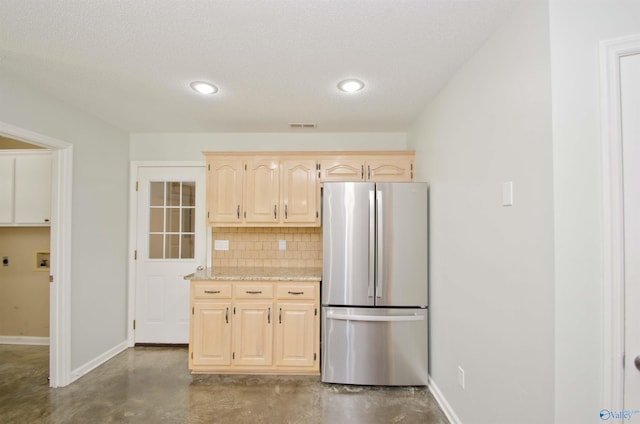 1422 Lake Crest Dr SW, Decatur, AL 35603 - kitchen with freestanding refrigerator, concrete flooring, light brown cabinets, backsplash, and baseboards