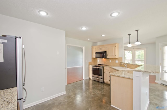 1422 Lake Crest Dr SW, Decatur, AL 35603 - kitchen with appliances with stainless steel finishes, a peninsula, a sink, backsplash, and light brown cabinetry