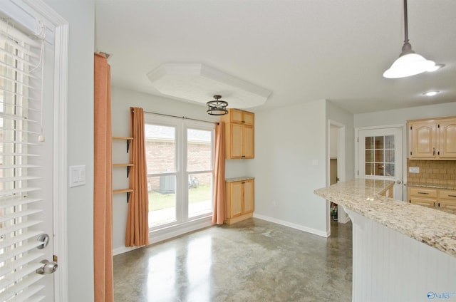 1422 Lake Crest Dr SW, Decatur, AL 35603 - kitchen featuring finished concrete flooring, baseboards, tasteful backsplash, light brown cabinets, and pendant lighting