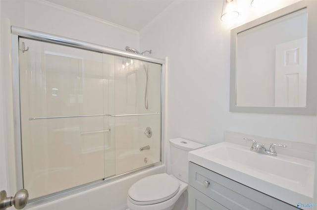 1422 Lake Crest Dr SW, Decatur, AL 35603 - full bath featuring crown molding, toilet, vanity, and bath / shower combo with glass door