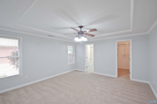 1422 Lake Crest Dr SW, Decatur, AL 35603 - unfurnished bedroom with a tray ceiling, a spacious closet, light colored carpet, crown molding, and baseboards