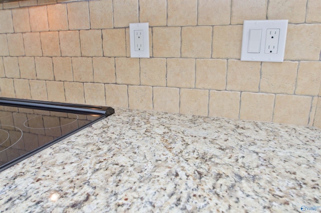 1422 Lake Crest Dr SW, Decatur, AL 35603 - kitchen view of decorative backsplash, black electric stovetop, and light stone countertops