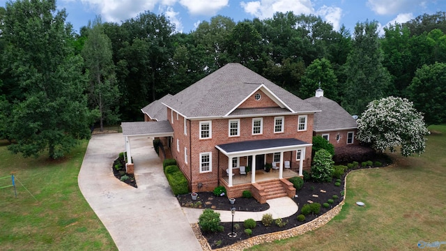 1211 SW Rountree Pl, Madison, AL 35756 - view of front of home featuring concrete driveway, covered porch, brick siding, and a front lawn