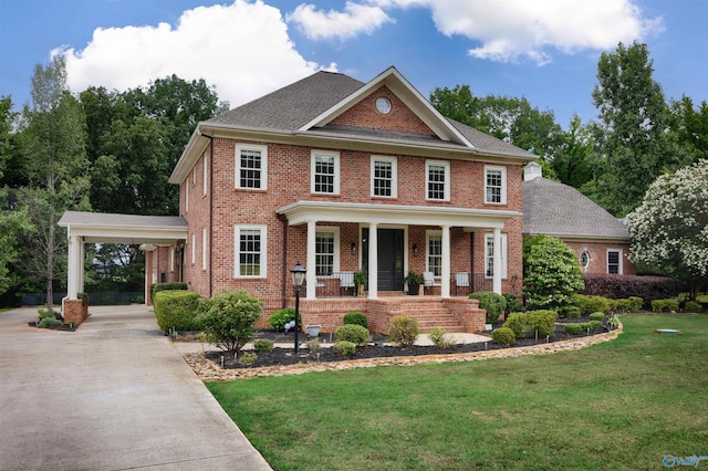 1211 SW Rountree Pl, Madison, AL 35756 - colonial inspired home with a porch, driveway, brick siding, and a front lawn