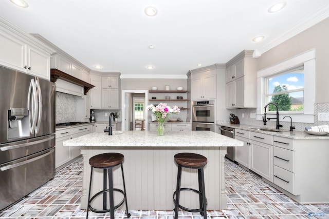1211 SW Rountree Pl, Madison, AL 35756 - kitchen with stainless steel appliances, brick flooring, a sink, open shelves, and ornamental molding