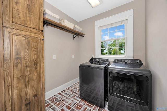 1211 SW Rountree Pl, Madison, AL 35756 - washroom with brick flooring, baseboards, and washing machine and clothes dryer