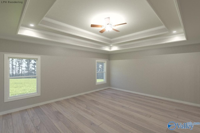 spare room featuring ceiling fan, crown molding, light hardwood / wood-style flooring, and a tray ceiling