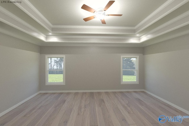 unfurnished room featuring light hardwood / wood-style floors, ornamental molding, and a tray ceiling