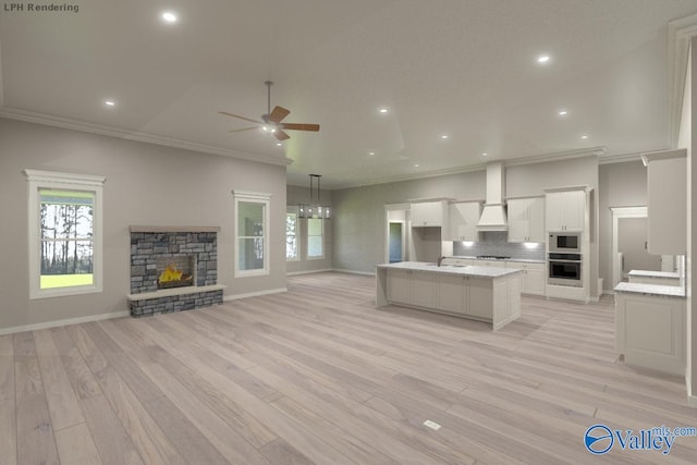 kitchen with a center island, stainless steel oven, white microwave, white cabinets, and tasteful backsplash