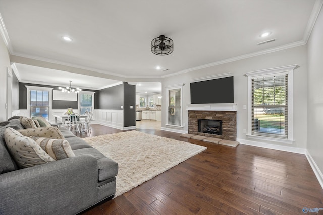 119 Saint Clair Ln, Huntsville, AL 35811 - living room with a chandelier, dark wood-style flooring, healthy amount of natural light, a stone fireplace, and crown molding