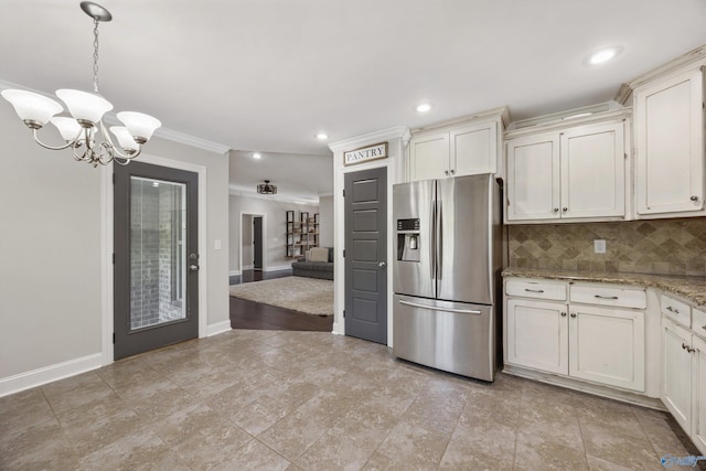 119 Saint Clair Ln, Huntsville, AL 35811 - kitchen featuring stainless steel refrigerator with ice dispenser, a chandelier, ornamental molding, tasteful backsplash, and light stone countertops