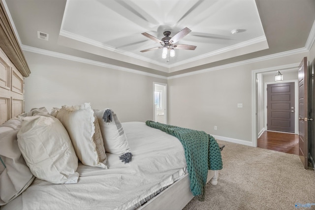 119 Saint Clair Ln, Huntsville, AL 35811 - carpeted bedroom featuring a tray ceiling, ornamental molding, a ceiling fan, and baseboards