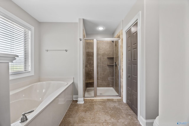 119 Saint Clair Ln, Huntsville, AL 35811 - full bath featuring a garden tub, a shower stall, and baseboards