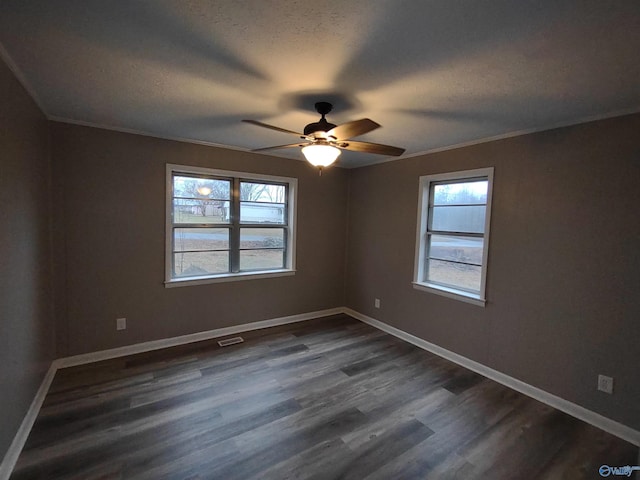 unfurnished room featuring a textured ceiling, dark wood-style flooring, a ceiling fan, visible vents, and baseboards