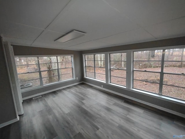 unfurnished sunroom featuring a paneled ceiling