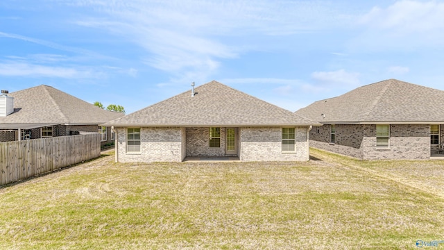 rear view of property with a yard