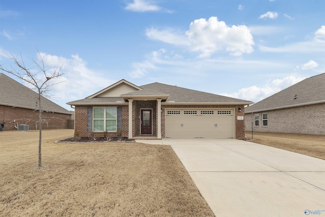 view of front of house with central AC unit, a garage, and a front lawn