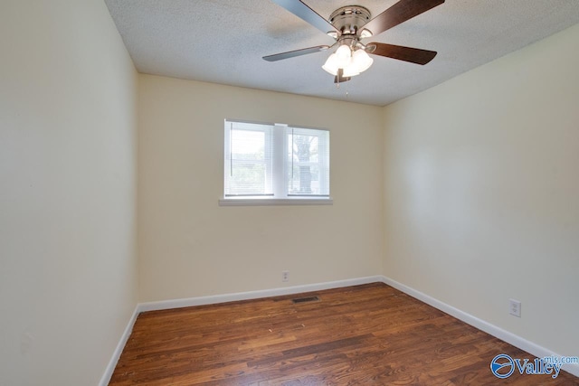 spare room with ceiling fan, a textured ceiling, and dark hardwood / wood-style flooring