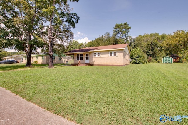 single story home with a front yard and a shed