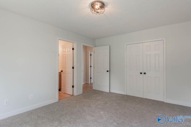 unfurnished bedroom featuring baseboards, a closet, and carpet flooring