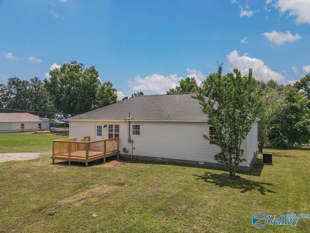 rear view of property with a yard, crawl space, and a wooden deck