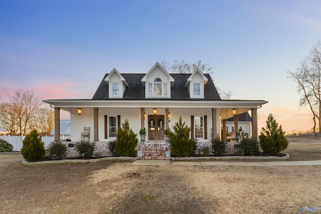 view of front of property with a lawn and a porch