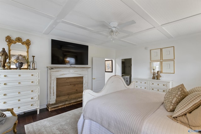 bedroom featuring dark wood-type flooring, coffered ceiling, ensuite bath, ceiling fan, and a high end fireplace