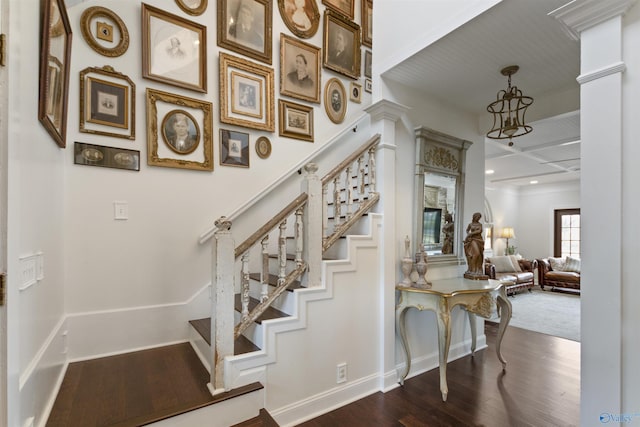 stairway with hardwood / wood-style flooring and ornate columns