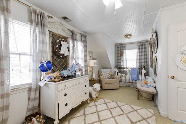 living area with ornamental molding and light carpet