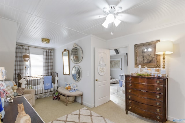 bedroom with ornamental molding, light colored carpet, and ceiling fan