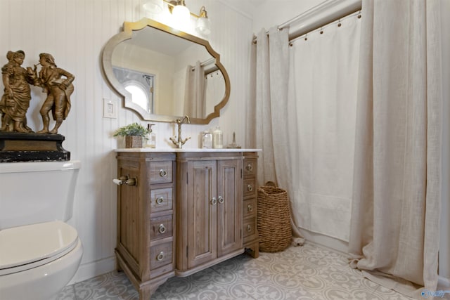 bathroom featuring tile patterned flooring, vanity, and toilet