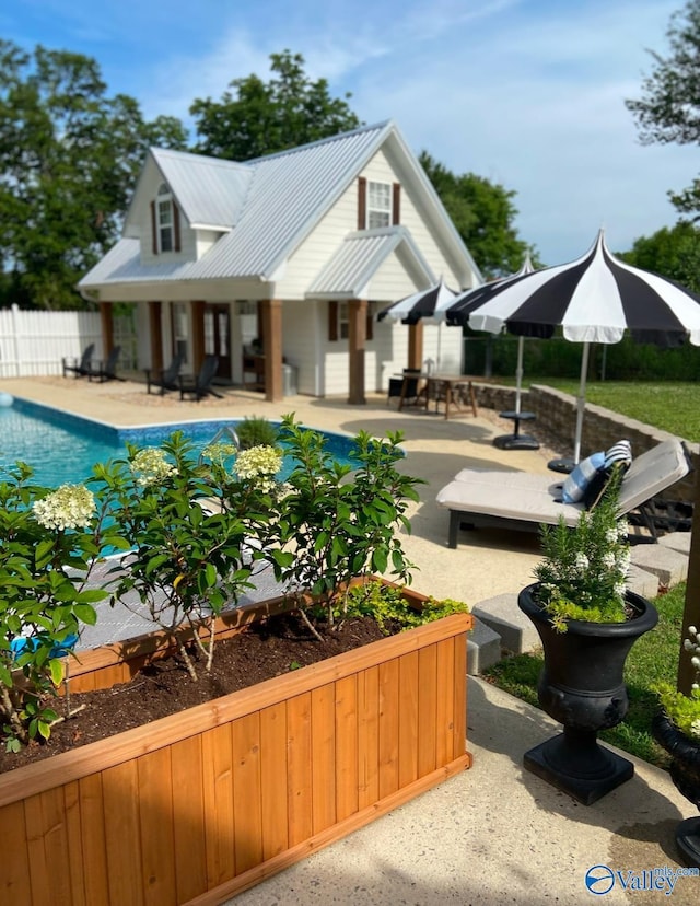 back of property featuring a fenced in pool and a patio