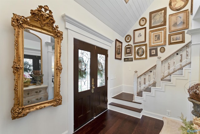 entrance foyer featuring vaulted ceiling, dark wood-type flooring, wood ceiling, and french doors