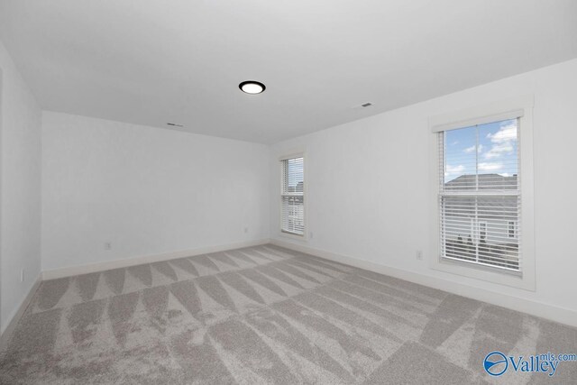 unfurnished room featuring carpet