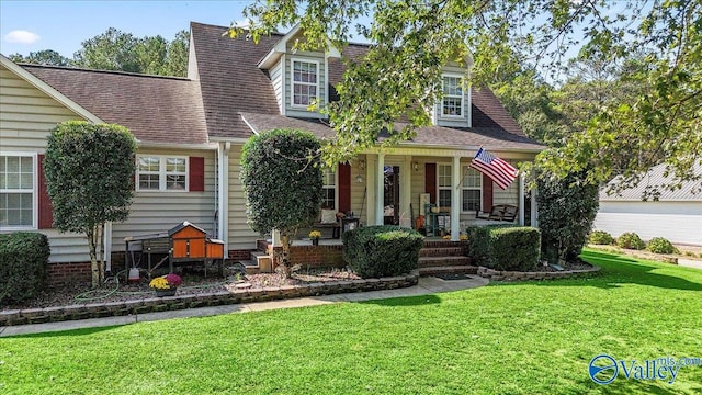 cape cod house featuring a front yard and a porch